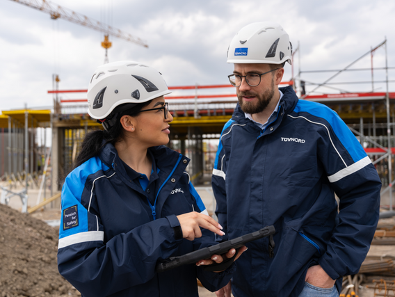 Two engineers talking in front of a building