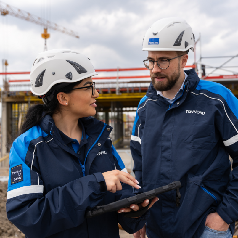 Two engineers talking in front of a building