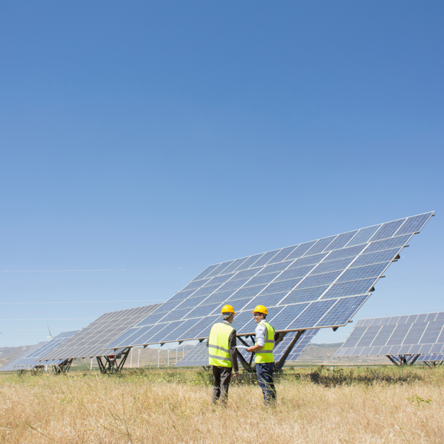 Two engineers are inspecting solar panels
