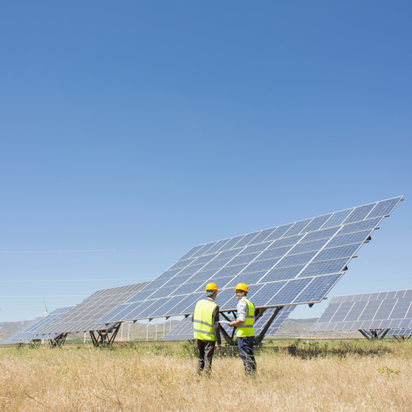 Two engineers are inspecting solar panels Two engineers are inspecting solar panels