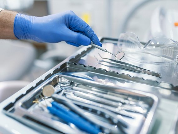 Dental tools and other accessories commonly used by dentists are arranged in a dental office setting