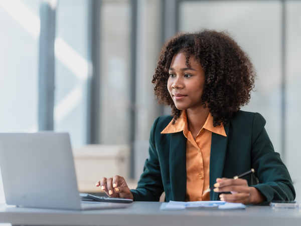 A person attending a conference or a meeting on her laptop. 