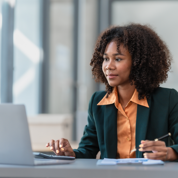 A person attending a conference or a meeting on her laptop. 