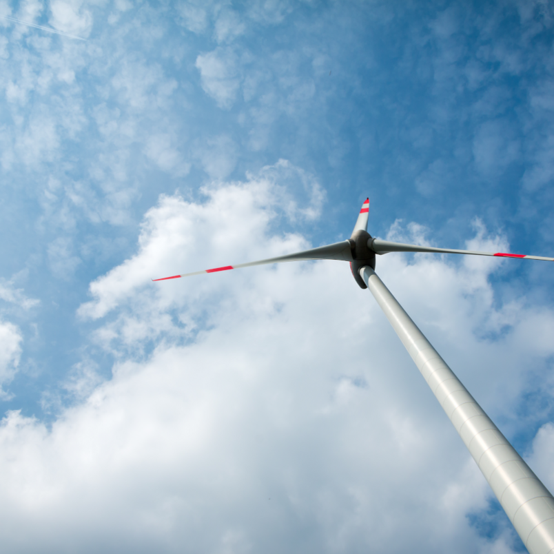 A solitary windmill with white clouds 