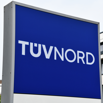 TÜV NORD sign prominently displayed outside corporate headquarters.