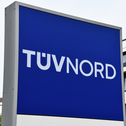 TÜV NORD sign prominently displayed outside corporate headquarters.