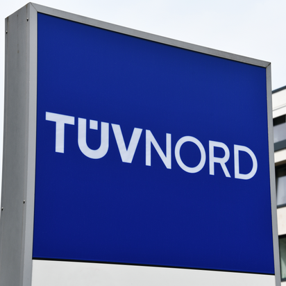 TÜV NORD sign prominently displayed outside corporate headquarters.