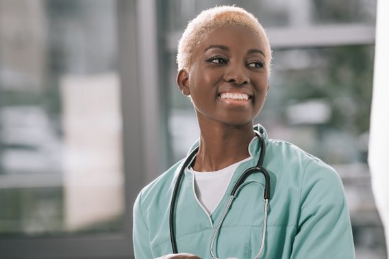 A healthcare doctor smiling and using a tablet A healthcare doctor smiling and using a tablet