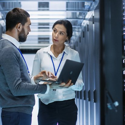 Two colleagues in a server room.