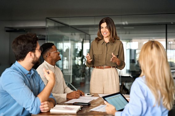 A female lead auditor explains something to her auditor colleagues