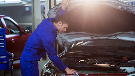 Mechanic servicing a car engine