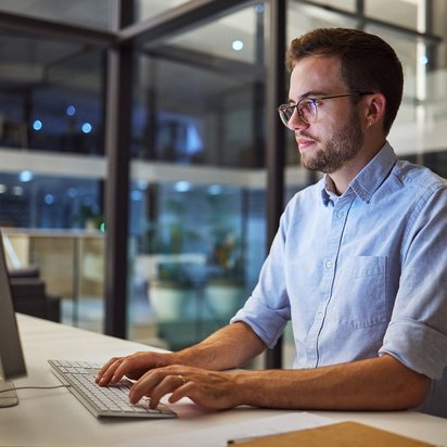 A man in front of his computer.